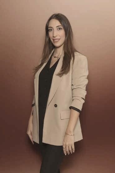Farah Abdul Khalek, Founder and Creative Director of Etoile Events, standing in a camel blazer.